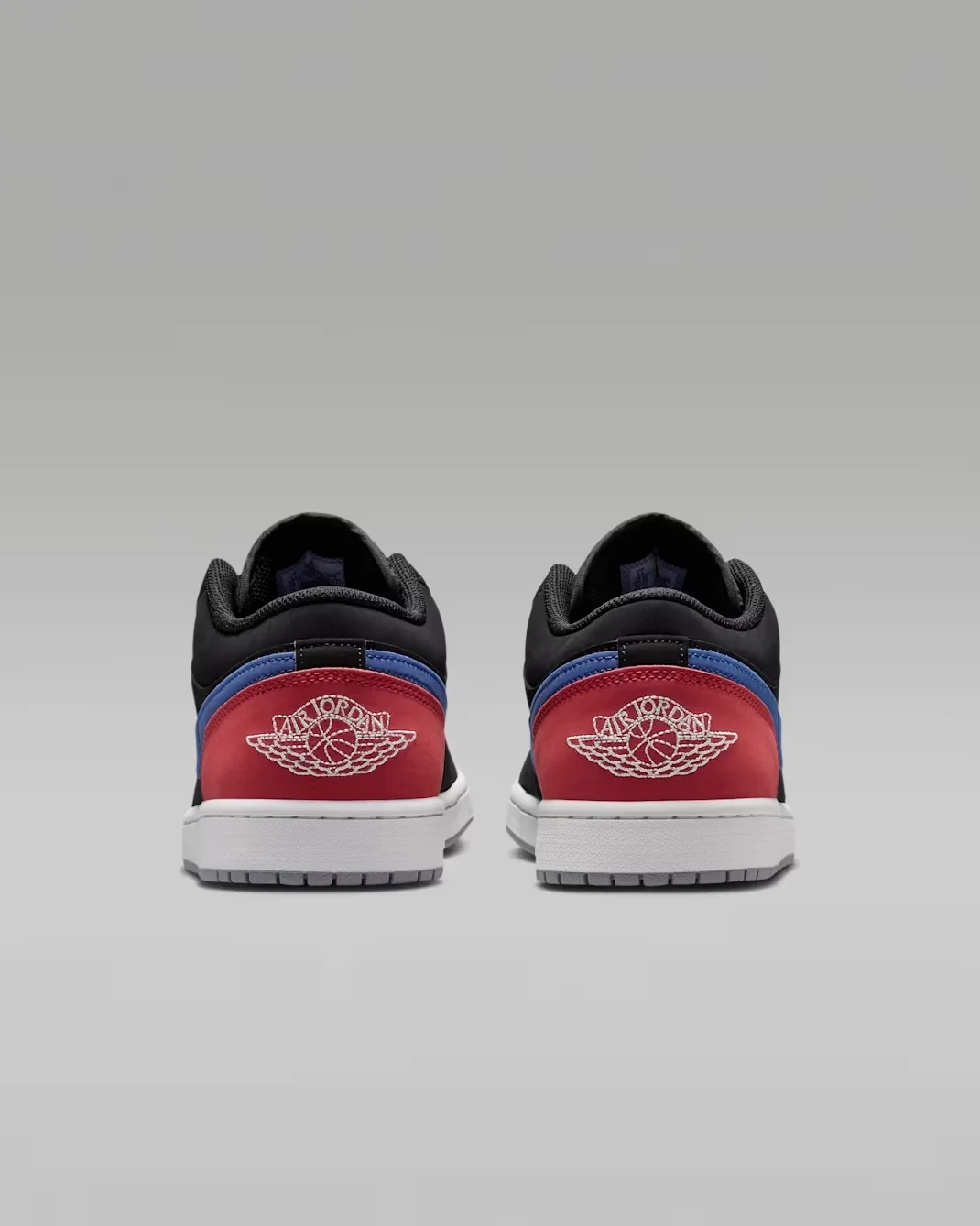 Rear heel view of the Air Jordan 1 Low Black True Blue Varsity Red Summit White with embroidered Wings logo.