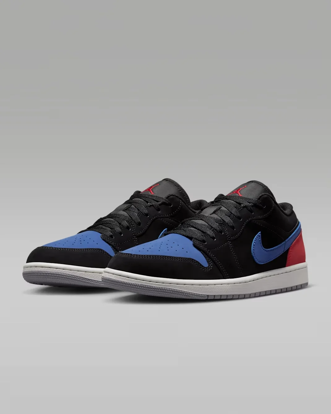 Pair of Air Jordan 1 Low Black True Blue Varsity Red Summit White sneakers displayed at an angle.